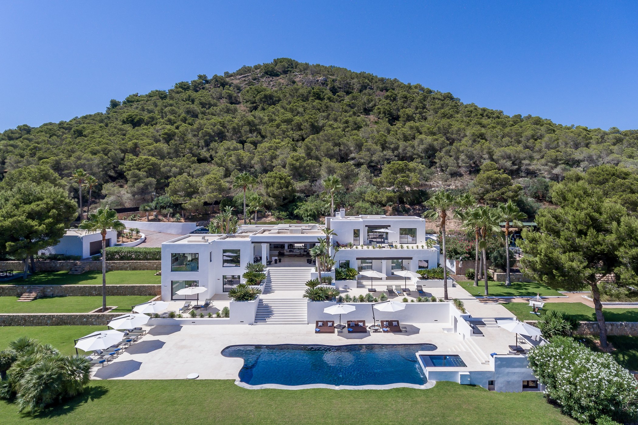 Front elevation of the luxury villa showing multiple terraces, steps and the main pool
